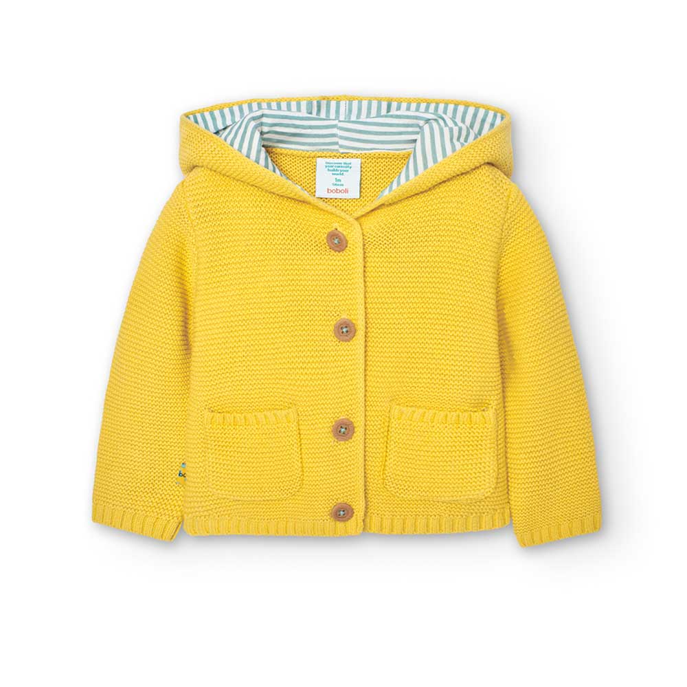 
Strickjacke aus der Boboli Kinderbekleidungslinie, mit Kapuze und kleinen Taschen auf der Vorder...