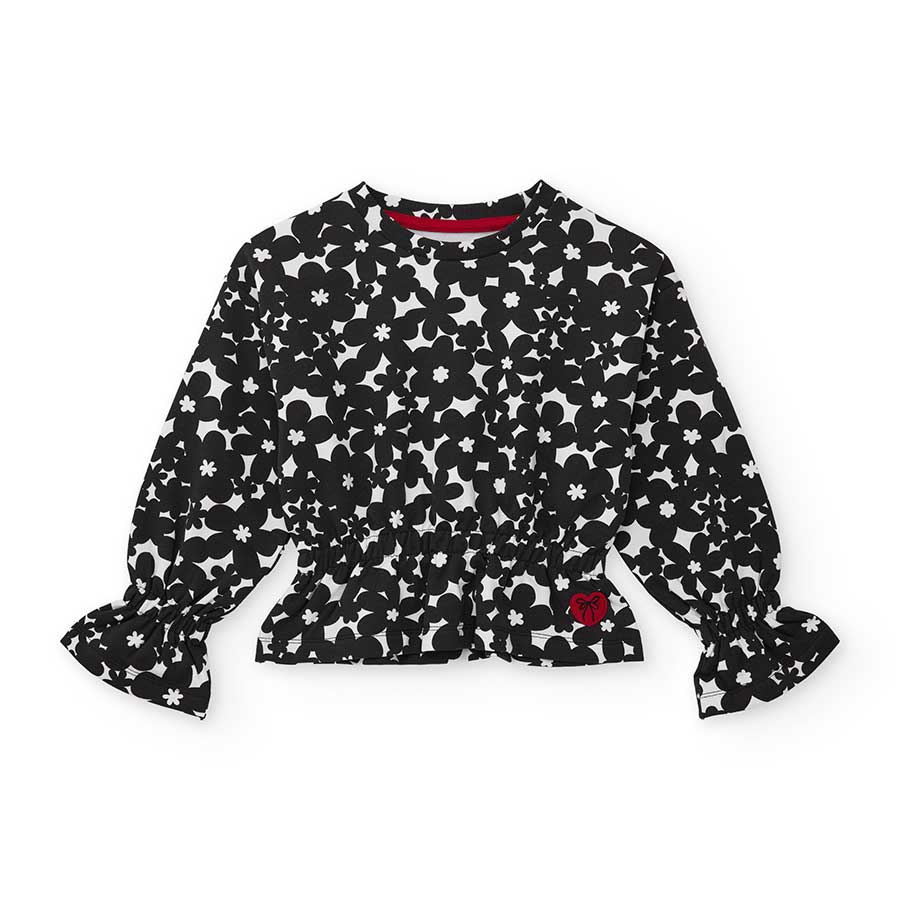 Entdecke dieses langärmlige Shirt, verziert mit einem bezaubernden Blumenmuster. Perfekt, um den ...
