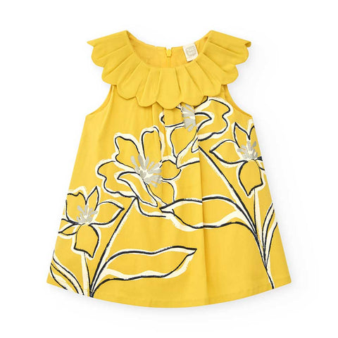 Abito giallo da bambina con colletto ampio e stampa floreale.