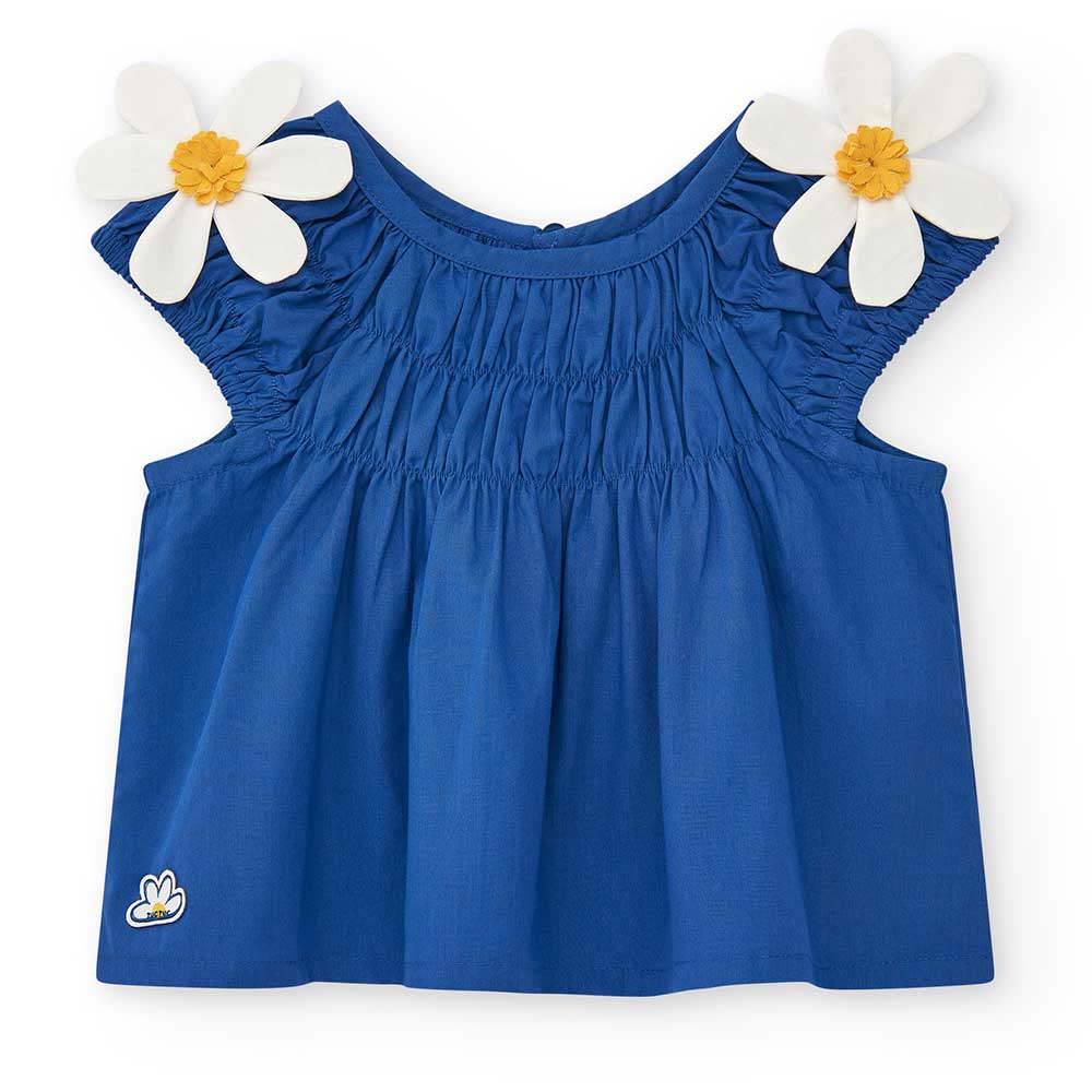 Bluse aus der Tuc Tuc Girls' Clothing Line, kurzes Modell mit Raffung am Oberteil. Auf den Schult...