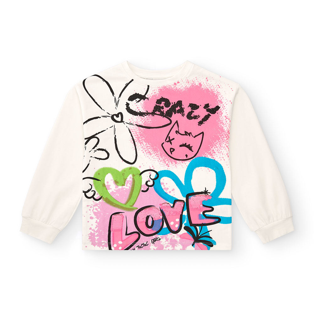 T-Shirt aus der Tuc Tuc Girls' Clothing Line, mit neonfarbenen Aufdrucken auf weißem Hintergrund....