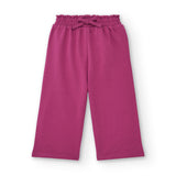 Pantaloni ampi di colore fucsia per bambina con elastico in vita.